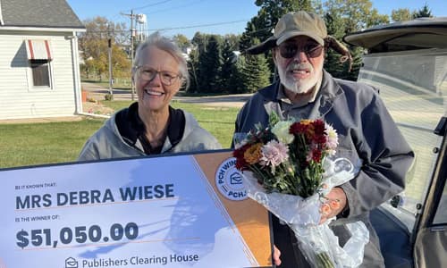 Debra Wiese holding a $51,050 Publishers Clearing House winner check