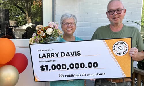 Larry Davis holding a $1,000,000 SuperPrize winner check